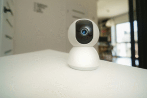 Close-up of a white indoor security camera on a tabletop