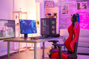 Personal gaming desk with a red gaming chair and dual monitor setup