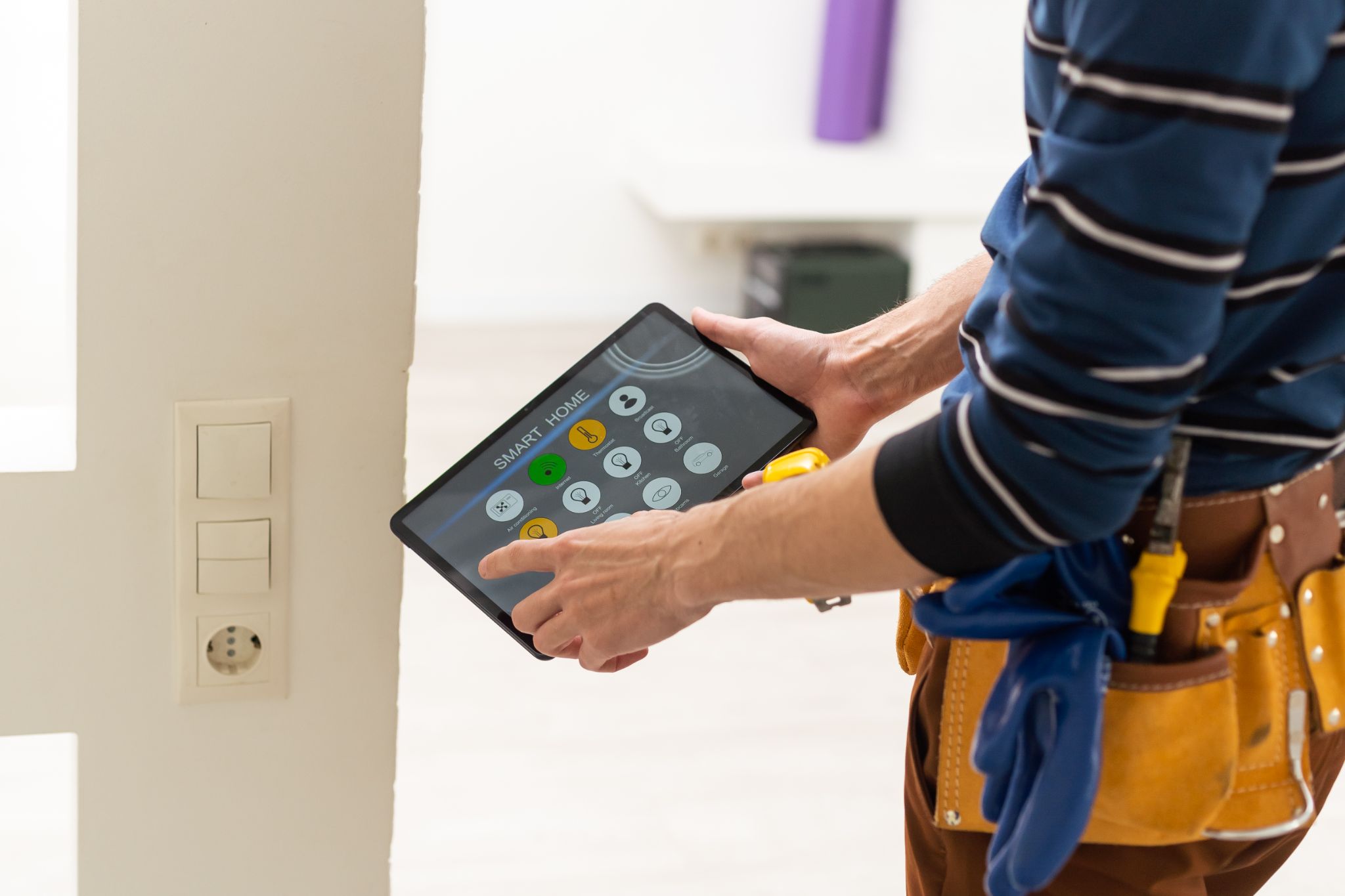 technician using a smart home automation application on a tablet