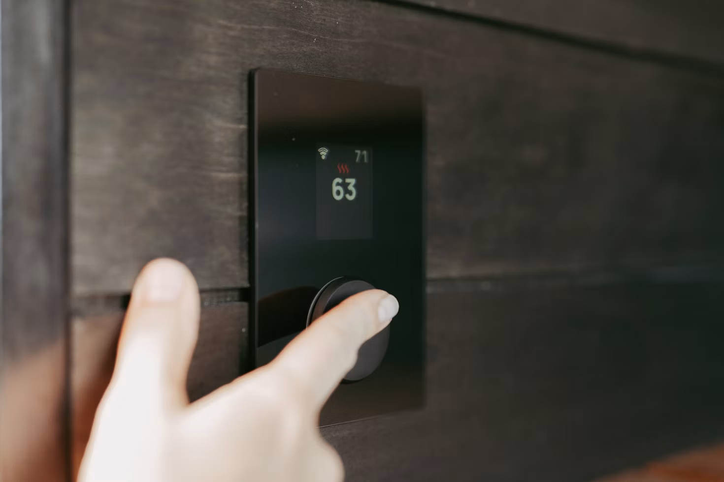 a person pressing on a temperature button interface